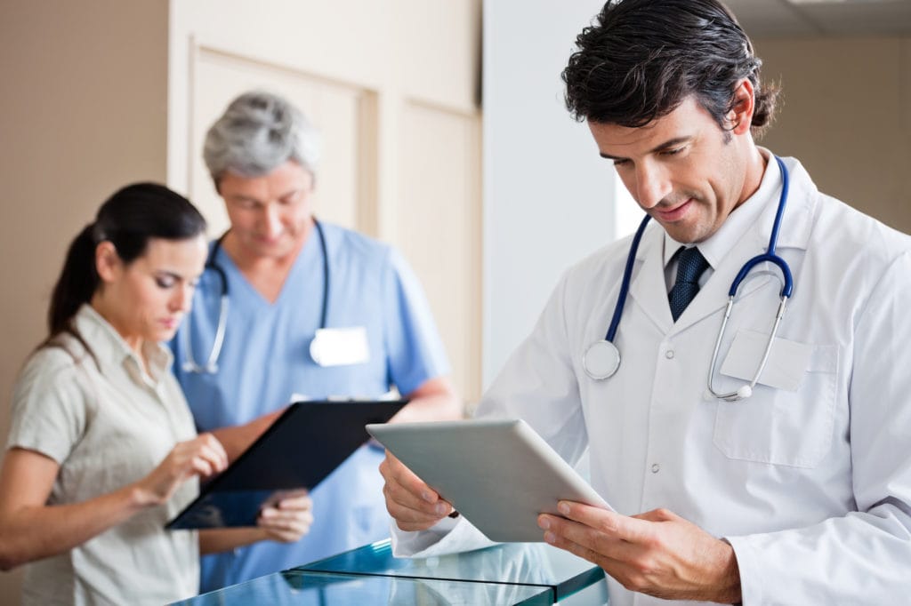 Doctors Using Integrated Software For Handling Patient Information.