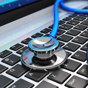 Stethoscope Lying On Top Of A Computer Keyboard.