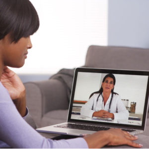 Patient Talking With Her Doctor Via Videocall During A Telemedicine Visit On Her Laptop.