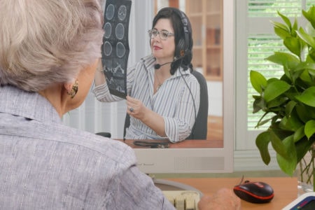 Patient talks to a doctor on a computer screen.