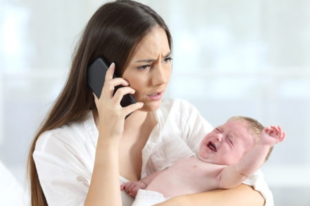 Mother calling doctor worried about her baby crying