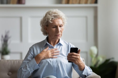 An Older Patient Is Worried About A Text Message On Her Phone.