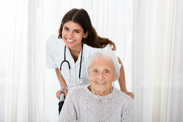 Homecare Nurse With Senior Citizen Patient In Wheelchair